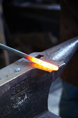Incandescent element in the smithy on the anvil