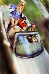 Young people having fun in cabriolet