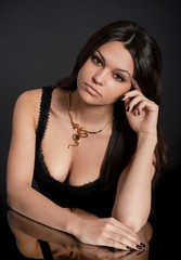 Portrait of beautiful young woman with golden jewelry