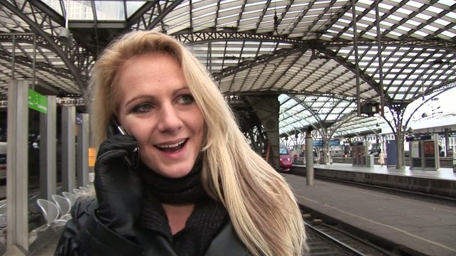Business woman on the phone on central station outside