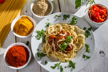 Spaghetti on a plate served with vegetables