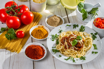 Ingredients and fresh vegetables to spaghetti