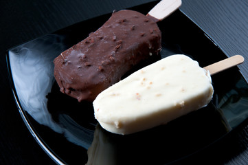 Chocolate ice cream on a black plate, studio shot