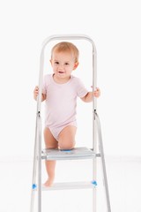 Cute baby climbing on ladder
