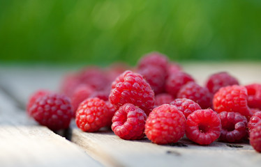Rasberries fruit on wooden background outdoor