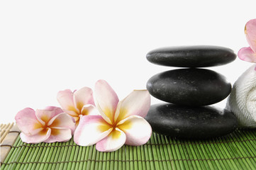 zen stone and frangipani flower showing spa or wellness concept