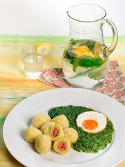 Stuffed potato dumplings with smoked meat and spinach