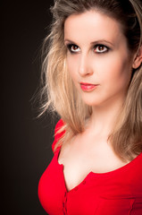 Young woman looking up against black background