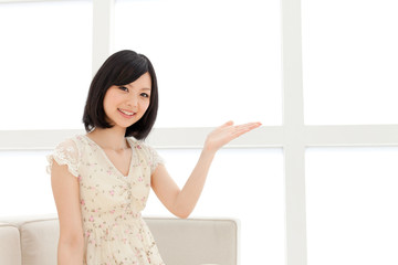 Beautiful young woman relaxing living room. Portrait of asian.