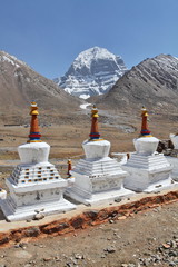 Buddhist statues in Tibet with holy Mount Kailash background
