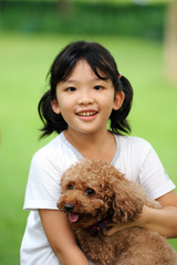 Asian kid playing with dog