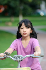 Obraz premium Asian kid riding bike