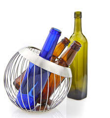 Empty glass bottles in wire basket isolated over the white backg