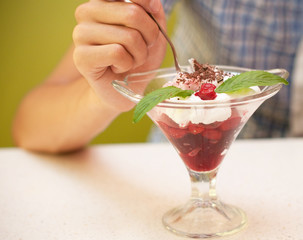 Delicious bowl of cherry ice cream and hand