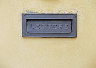 mailbox on a yellow wall in Italy