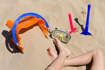 child playing with toys on beach