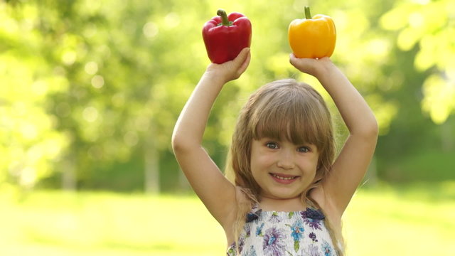 Portrait of a girl holding the hands of vegetables