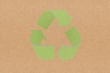 White recycle sign on recycled paper background