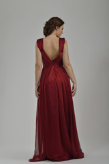 Fototapeta premium elegant woman in fashionable dress posing in the studio