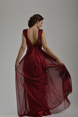 elegant woman in fashionable dress posing in the studio