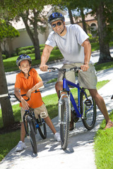 Obraz premium African American Man & Boy, Father and Son Riding Bikes