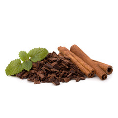 Crushed chocolate shavings pile and cinnamon sticks