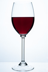 Glass of red wine on a white background.