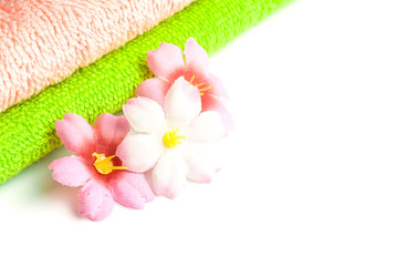 Stack of towels and flowers.