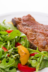 cervical chop with apricot-rocket salad