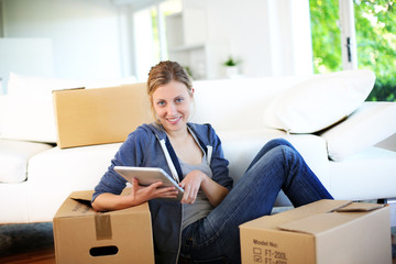 Young girl websurfing on tablet in new flat