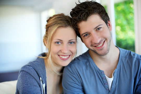 Closeup of cheerful young couple wearing blue