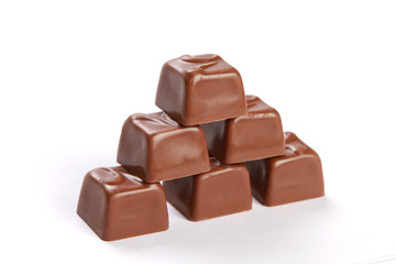 Broken chocolate tower isolated on white background