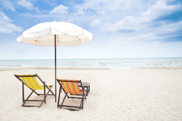 colorful beach chair on sandy beach and clear blue sky