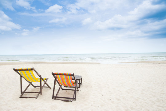 Beach chair on white sandy beach and clear sky