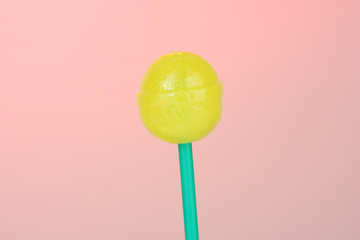 Sweet and tasty lollipop on pink background close-up
