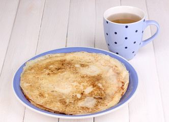 Stack of tasty pancakes on wooden background