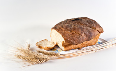 Loaf and slice of wheat bread with wheatears