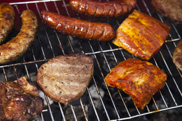 Grilling meat in flames, tasty dinner 