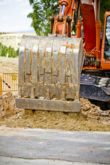 Orange excavator on a working platform