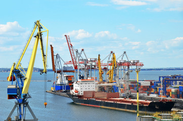 Fototapeta premium Container stack and ship under crane bridge