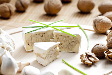 cheese brie filled with cheese mixture of chopped walnuts and ga