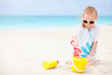 Little girl with beach toys