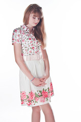 A young and beautiful woman in elegant dress isolated on white b