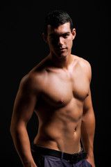 Fototapeta na wymiar Healthy muscular young man. Isolated on black background.