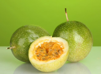 Fototapeta na wymiar green passion fruit on green background close-up