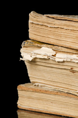 Pile of old books on black