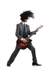 Guitar player in business suit on white