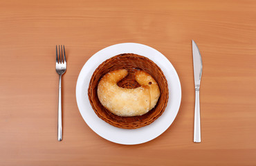 Fresh crossant on white plate