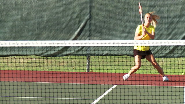 Girl playing tennis in slow motion
