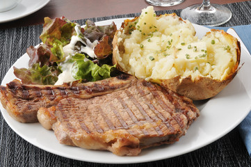 Grilled rib steak with baked potato